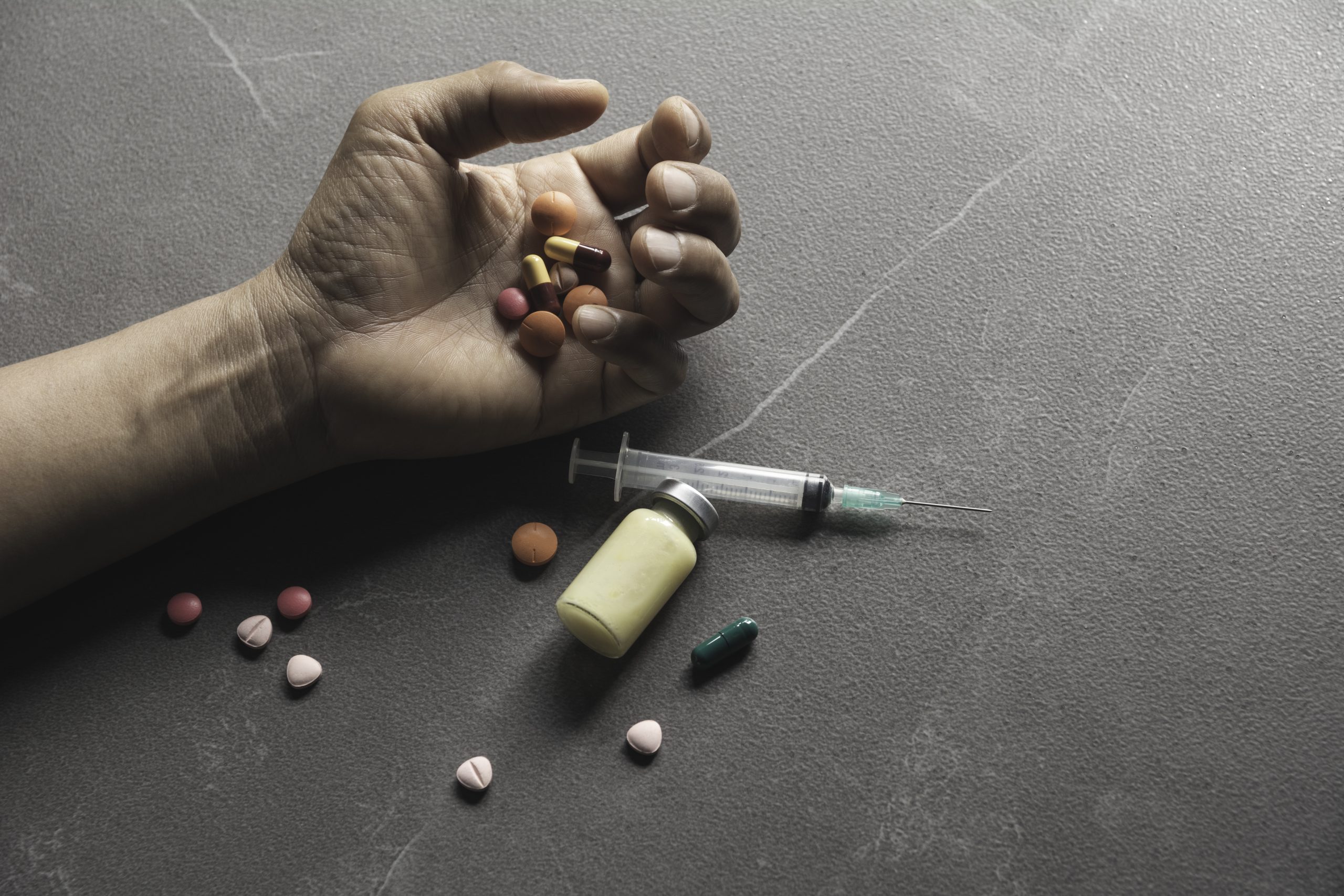 The man committing suicide by overdosing on medication. Close up